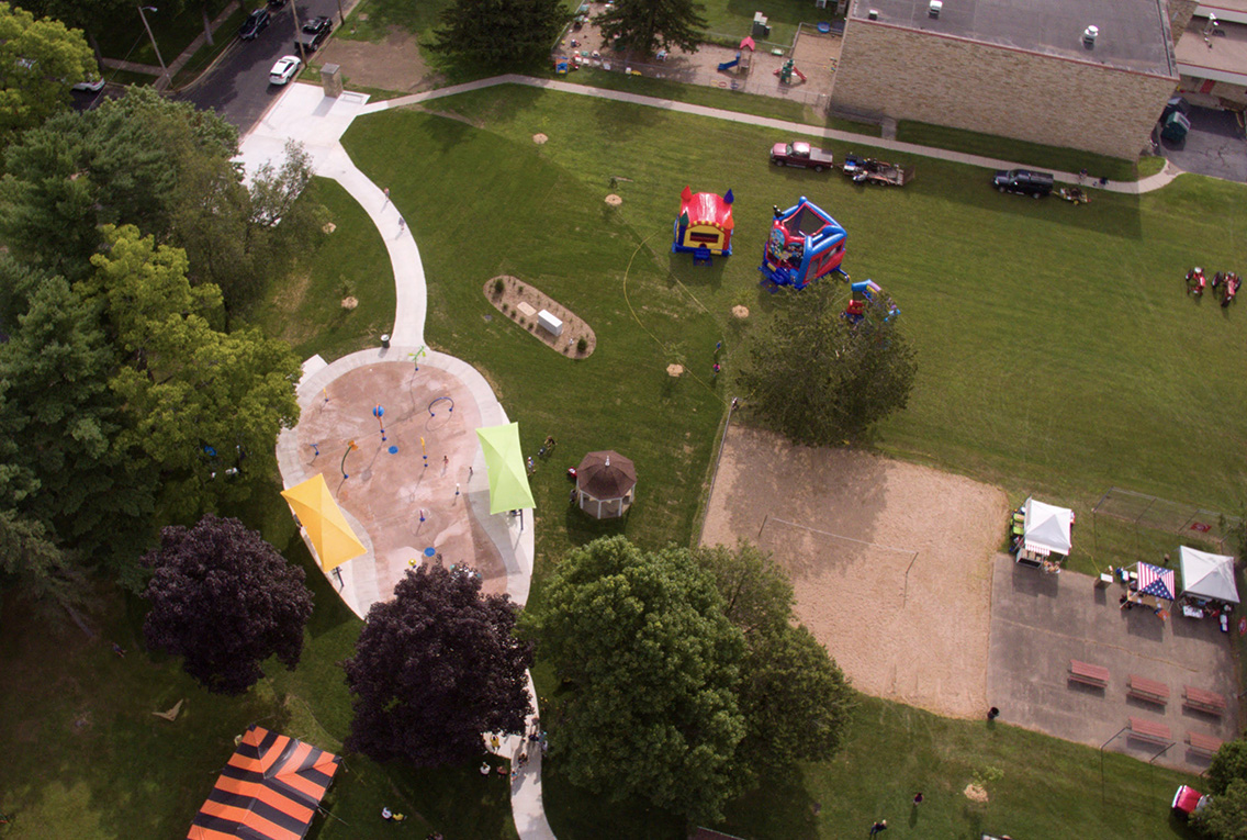 Aerial drone photo of the grand opening and ribbon-cutting of a new splash pad in the Village of Port Edwards, Wisconsin, as designed by MSA Professional Services. 