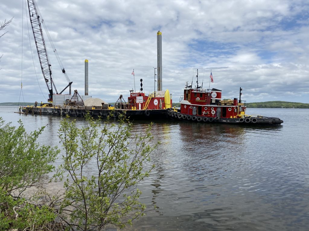 A barge hauls materials to the construction site of a new ADA fishing pier and dock at Potawatomi State Park in Wisconsin