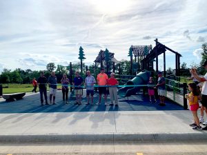 Ribbon cutting ceremony to mark the grand opening of a colorful new playground and splash pad at Turtle Creek park in Hiawatha Iowa