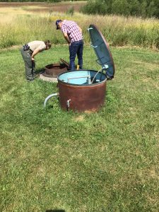 Park ranger and MSA wastewater engineer investigate manholes at Myre-Big Island State Park in Minnesota as part of a wastewater system re-design. 