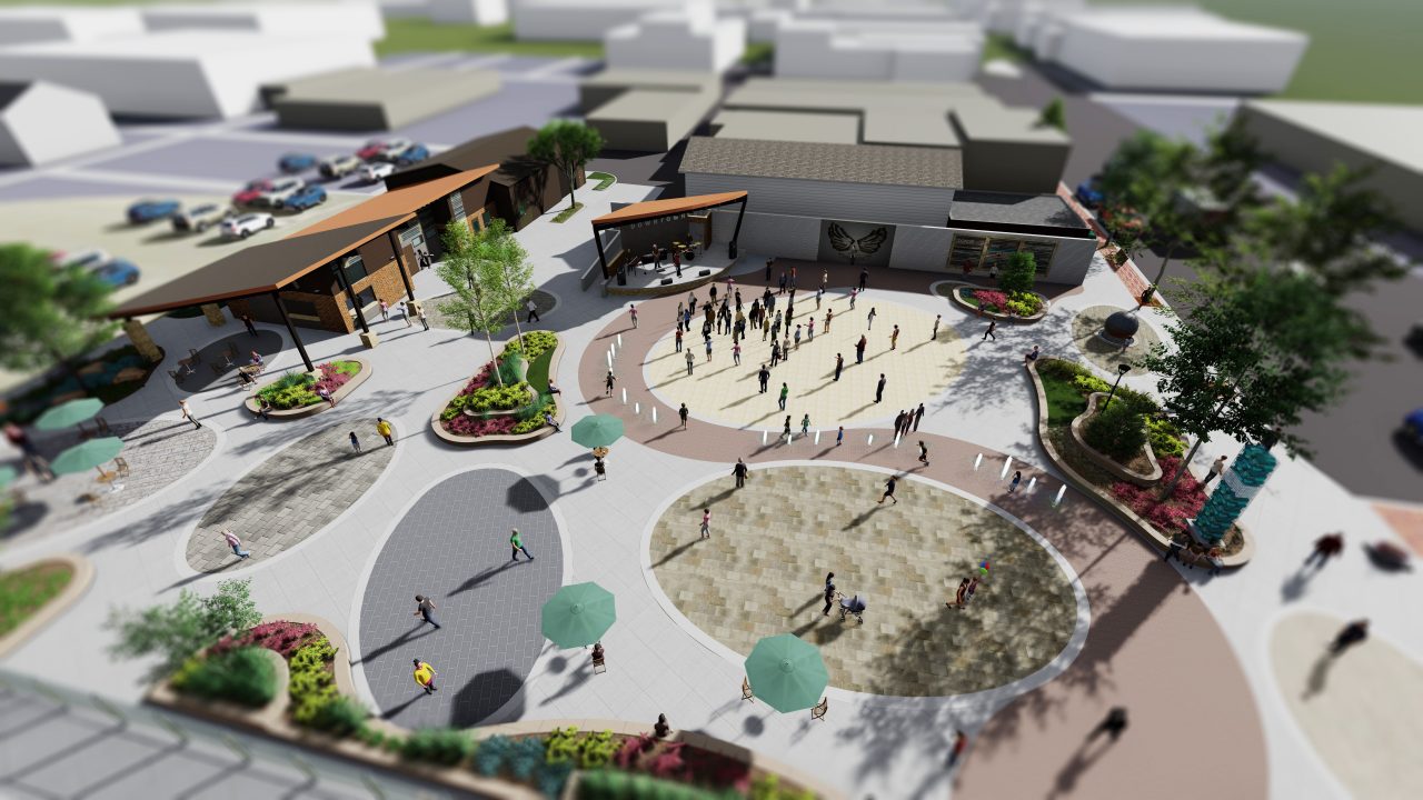 Design rendering of a new public plaza and event space along Elm Street in Wisconsin Dells, with community stage, water features, and landscaping.