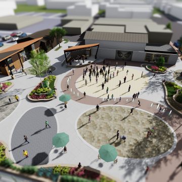 Design rendering of a new public plaza and event space along Elm Street in Wisconsin Dells, with community stage, water features, and landscaping.