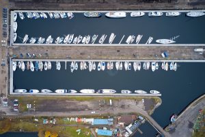 Aerial view of Marina with boats and yachts from above in row 