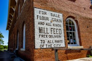 Close-up photograph of a historic brick grain mill building in Independence Iowa